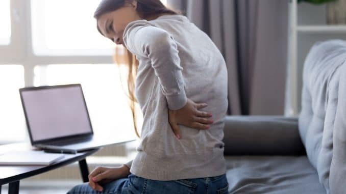 Young woman feeling backpain