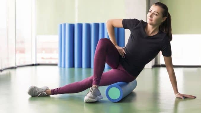 female doing foam roller exercise