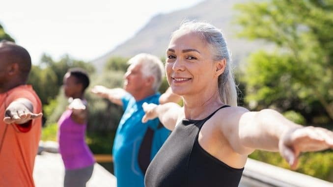 Senior woman stretching arms