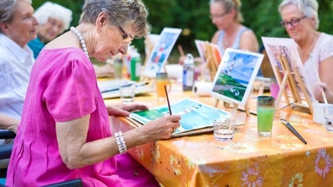 Stylish senior lady painting