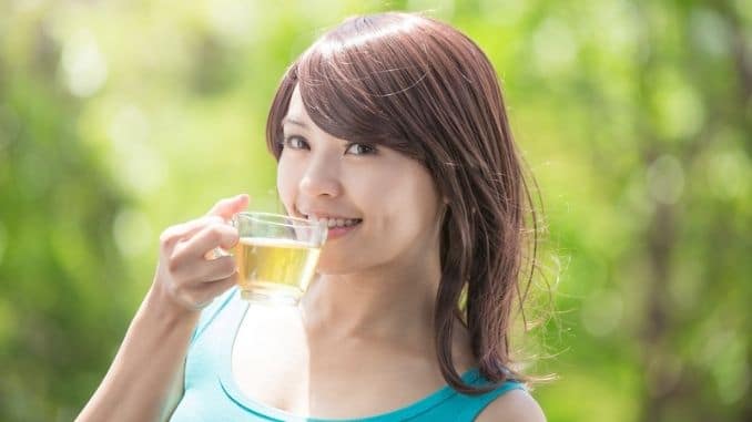 Young Woman drinking green tea