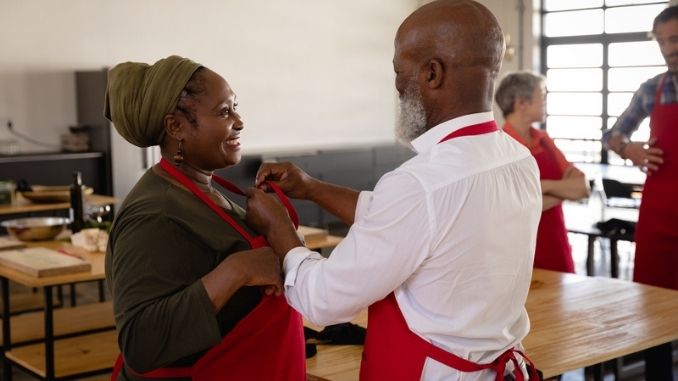 helping to put on her apron