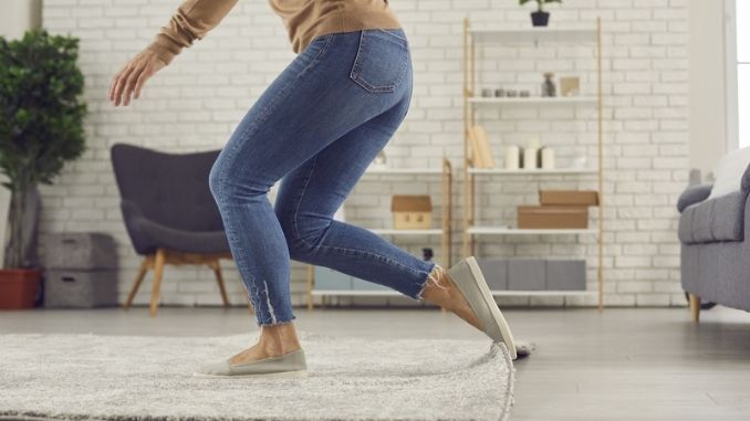 woman trips over the rug