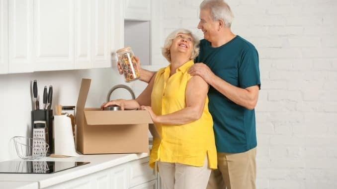 couple unpacking moving box