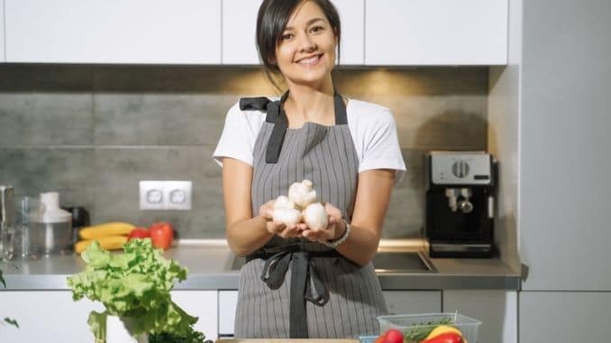 woman-holding-mushrooms