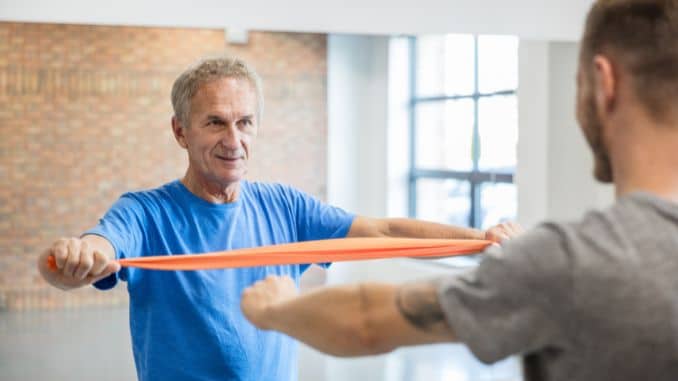 senior-man-exercising-with-resistance-band - Standing Band Exercises