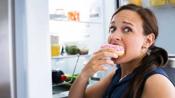 hungry woman eating donuts