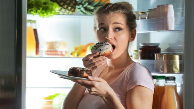 wary-woman-eating-unhealthy-food