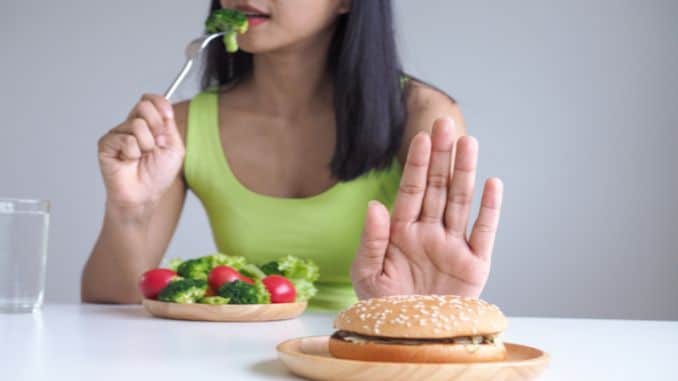 woman-refusing-to-eat-fast-food - self sabotaging with food